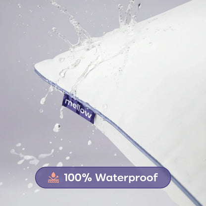 Water splashing on a white waterproof pillow with blue trim and mellow tag