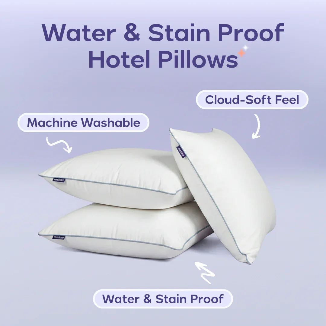 Stack of three water and stain proof hotel pillows, machine washable with cloud-soft feel.